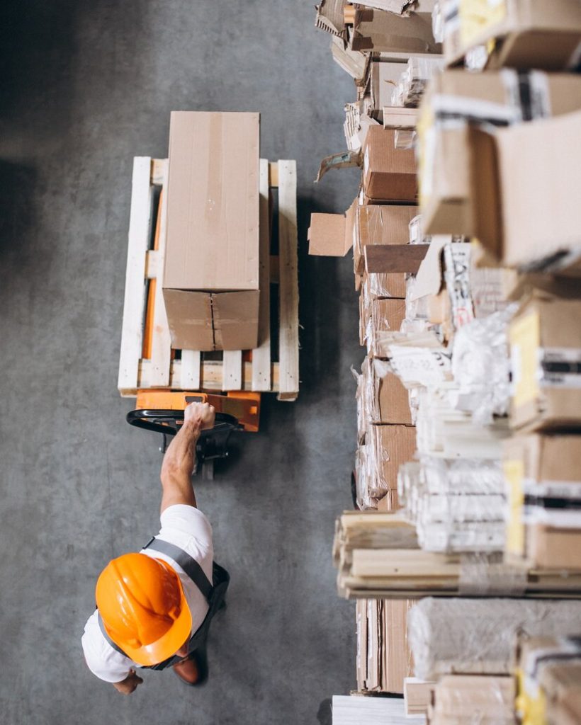 young-man-working-warehouse-with-boxes_1303-16615